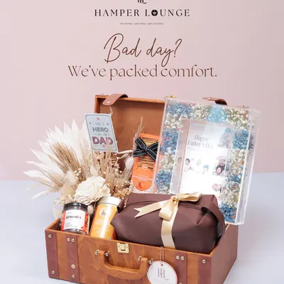 Dads have different moods, and my hampers match them. This vintage-style suitcase hamper is packed for comfort on a bad day, with snacks, brews, and a personalized photo frame for Father's Day.