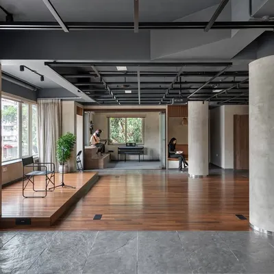 This wide view of the 'Chasing Tales' incubator captures the essence of our design: an open, fluid space with clearly defined functional zones. The elevated stage area provides a focal point, while breakout spaces and reading nooks are integrated along the periphery for quieter activities.