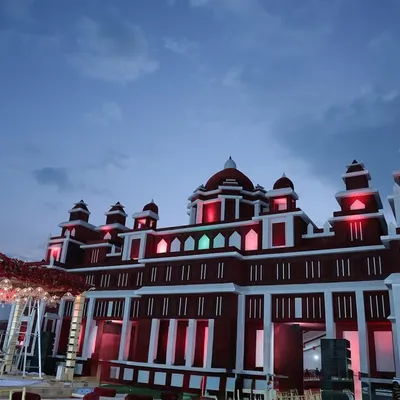 We transformed this venue by constructing a grand facade resembling a red and white Rajasthani palace, creating an immersive and royal experience from the moment guests arrived.