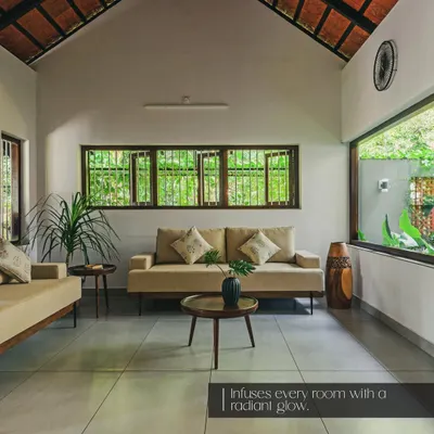 A tranquil living space where my custom sofas are complemented by carefully chosen accents, including a mid-century modern coffee table, indoor plants, and a beautifully carved wooden vase that adds a touch of traditional art.