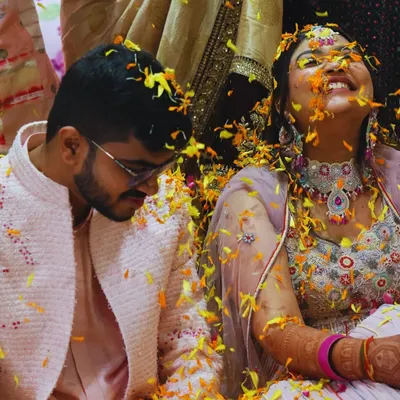 A moment of pure, unscripted joy during a 'Phoolon ki Haldi'. We believe the best memories are made when you're surrounded by love, laughter, and a shower of flower petals.