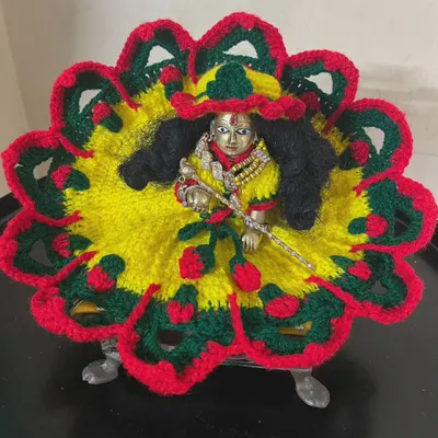 A bright and colorful woolen poshak worn by Laddu Gopal. The combination of yellow, red, and green makes it a cheerful outfit for the winter season.