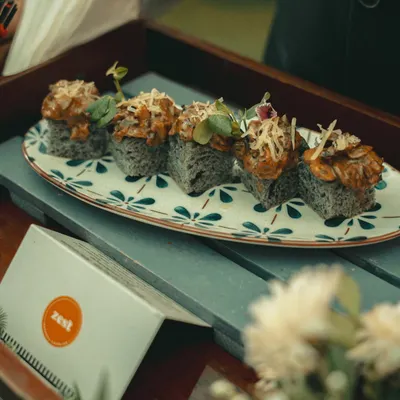 Artfully plated sushi appetizers on a decorative platter, showcasing our attention to presentation.