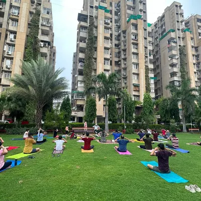 Celebrating International Yoga Day with a large community session in a park. Practicing outdoors, surrounded by greenery and fresh air, adds a powerful dimension to the experience, connecting us to the earth.