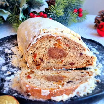 A classic German Christmas Stollen, a bread-like fruitcake filled with dried fruit and a center of marzipan. I teach the traditional recipe for this festive holiday bake.