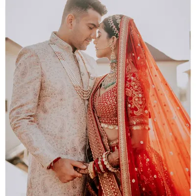 An intimate close-up of the couple, their foreheads touching, capturing a moment of quiet connection in their wedding attire.