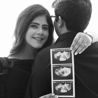 A beautiful way to announce your journey. This black and white shot focuses on the joy in her eyes and the precious sonogram, telling the story of what's to come.