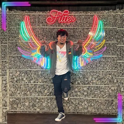 Posing in front of a neon angel wings sign at Filter in Koramangala. This reflects my belief that discipline is what keeps you growing.