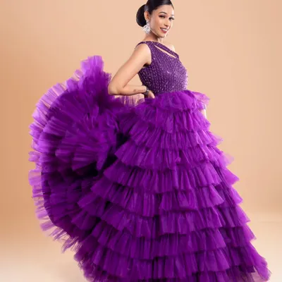 This vibrant purple layered gown is designed to make a statement. The ruffled skirt creates incredible volume and movement, perfect for photos where you want to show off your outfit.