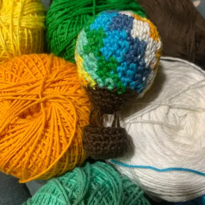 I made this little hot air balloon completely free-handed, just using different colors of yarn to create the design. It was a really fun personal project to figure out without a pattern.