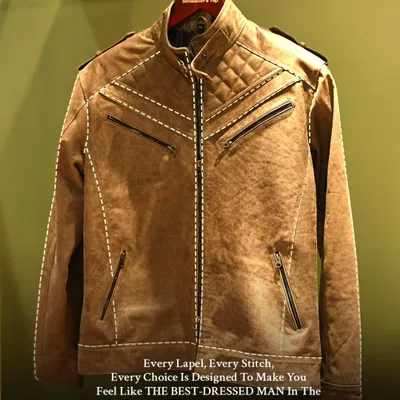This brown leather jacket showcases our skill in crafting structured outerwear. The design features quilted shoulders and multiple zippers, blending a modern biker aesthetic with bespoke precision.