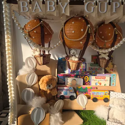 A different angle of the 'Baby Gupta' hot air balloon hamper, showing the arrangement of toys and books on the custom shelf.