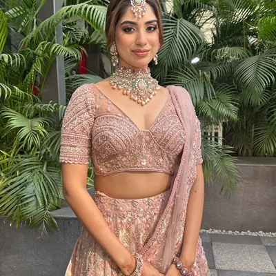 This bride looks like she stepped straight out of a Pinterest board. I created a soft, romantic makeup look and a beautiful textured bun to complement her dusty pink lehenga.
