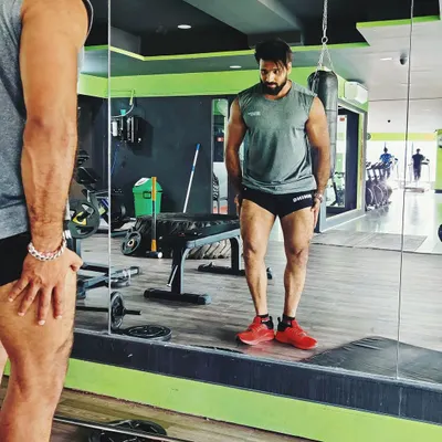 I LOVE LEG DAY! Admiring the quad development in the mirror. This is the result of consistent, heavy training.