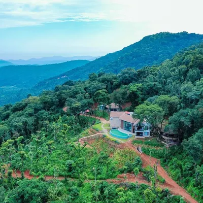 An aerial view of our 'Abode in the Mountains' project in Chikmagalur. The residence is carefully sited to maximize the spectacular views of the Western Ghats while minimizing its impact on the lush landscape.