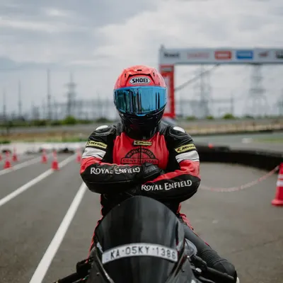 A rider in full gear, focused and ready on the track. This image captures the determination and passion that defines our community.