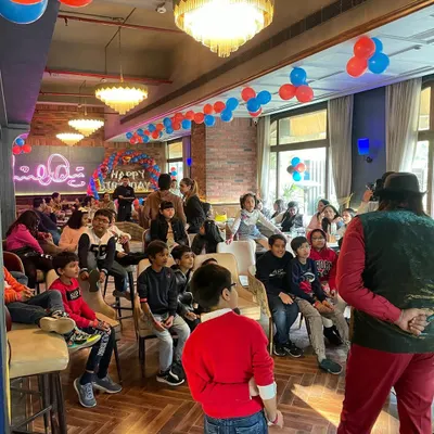A magician captivating an audience of kids and adults at a birthday party. My entertainment services are designed to keep guests of all ages engaged and amazed.