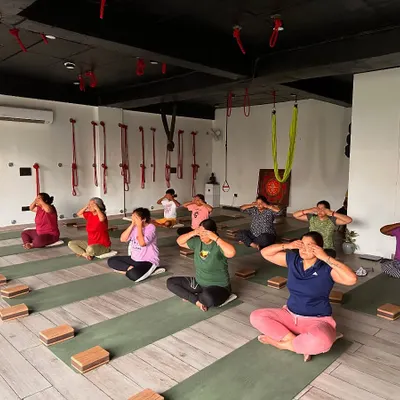 A group of students practicing Bhramari Pranayama (Humming Bee Breath). This technique is incredibly effective at calming the mind, relieving frustration, and preparing the consciousness for meditation by turning the senses inward.