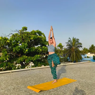 Finding stillness and strength in Vrikshasana (Tree Pose) on the rooftop. This balancing pose improves focus and concentration while grounding your energy.