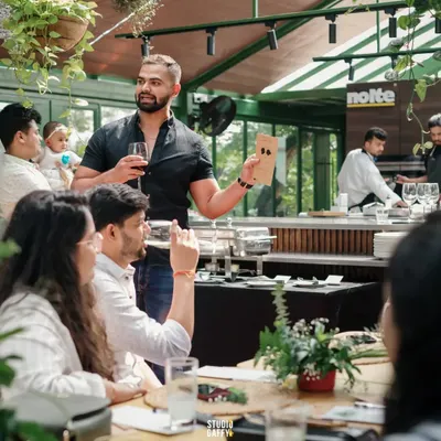 Performing close-up magic in a more intimate setting. This format is perfect for private parties or breaking the ice at networking events, as I engage with small groups directly at their tables.