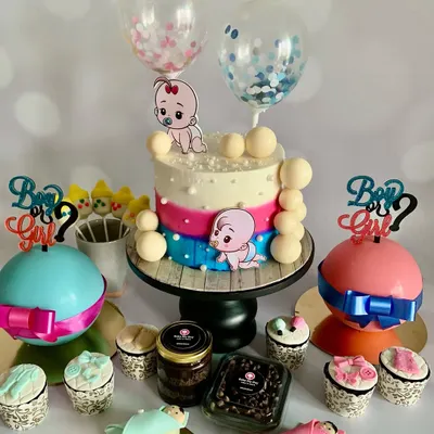 This gender reveal dessert table has it all: a themed cake, "Boy or Girl?" breakable hammer cakes for the big reveal, baby-themed cakesicles, cupcakes, and chocolate jars. It's a sweet feast for the eyes and the taste buds.