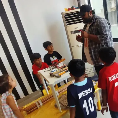 An instructor introduces a group of young learners to basic woodworking tools. We start with the fundamentals of tool handling and safety before any building begins.