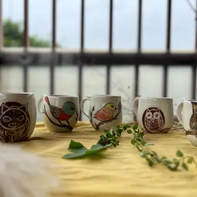 This lineup of mugs includes a special one with a dog portrait. I love capturing the sweet faces of pets in my work.