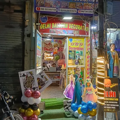 This is my shop, Delhi Balloon Decoration, located at Balaji Chowk in Uttam Nagar. You can see some of the character cutouts and decoration materials I have available.