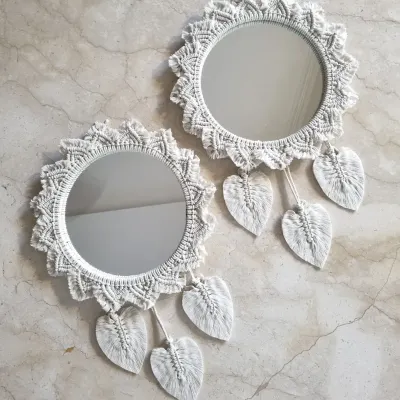 Add a touch of artisan charm to your space with these white macrame mirrors. The intricate knotting and leaf details make them a beautiful and functional addition to any wall.