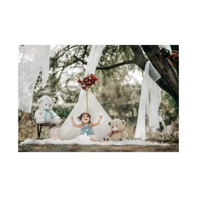A moment of pure joy in our outdoor teepee setup. This little girl's arms are wide open, embracing the fun of her whimsical teddy bear picnic.