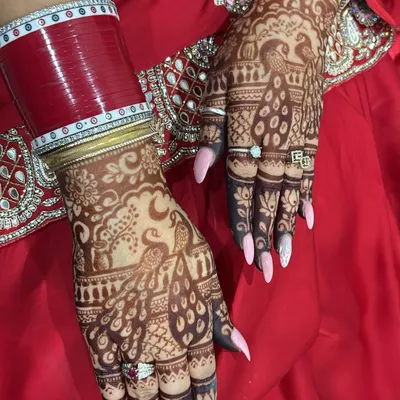 A beautiful Karwa Chauth design featuring peacocks and a crescent moon. The fine line work and shaded details make the motifs stand out.