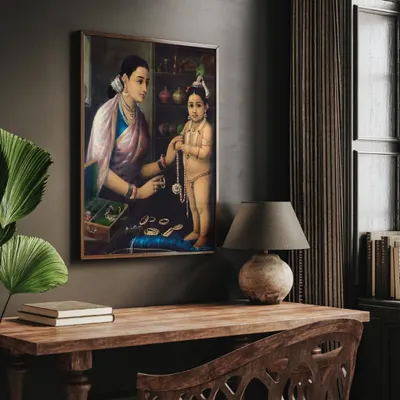 A beautiful print of Raja Ravi Varma's classic painting, "Yashoda Adorning Krishna." This piece captures a tender moment in exquisite detail, bringing a touch of classical Indian art and spiritual elegance to your study or traditional living space.