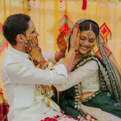 A joyful, candid moment as the bride and groom playfully apply haldi to each other. This is the kind of happy chaos I love to capture.
