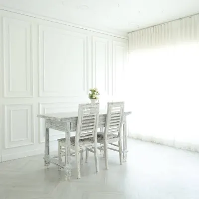 This is the heart of my studio: an all-white, elegant space filled with natural light. The paneled walls, distressed furniture, and sheer curtains create a perfect canvas for everything from classic portraits and lookbooks to clean product photography.