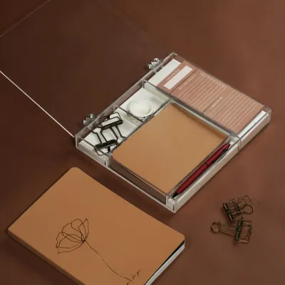A modern stationery set featuring a journal and an acrylic organizer, styled with minimalist clips and a pen. The clean, brown-toned aesthetic is perfect for a sophisticated, organized workspace.
