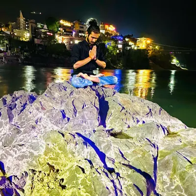 A moment of peace and meditation by the Ganga in Rishikesh at night. Connecting with nature and stillness is the essence of yoga.