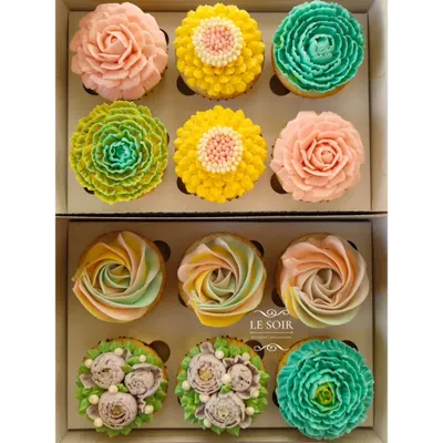 A whole garden of eggless cupcakes. This shows the variety of floral designs I can create using my less-sweet buttercream, from delicate rosettes to vibrant, multi-layered blossoms. Each one is piped by hand.