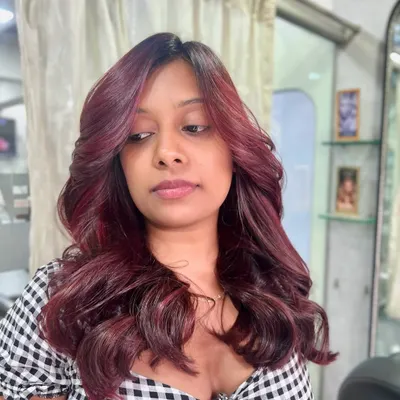 Who says hair can’t make a statement? This fiery red look is bold, vibrant, and full of personality, styled with soft waves to show off the rich dimension.