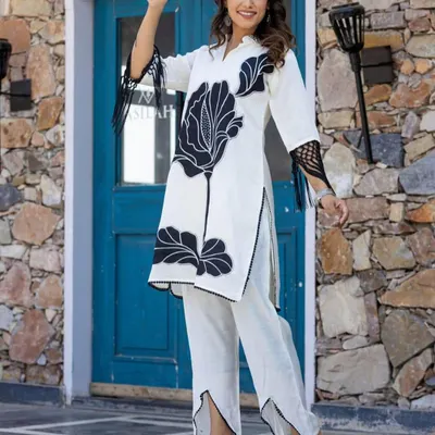 This black and white cord set makes a bold statement with its large floral print. The coordinated top and bottom create a polished, modern Indian outfit that is both comfortable and stylish.
