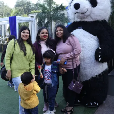 Our panda mascot is a crowd favorite, seen here posing with a family at an outdoor event. These gentle giants are perfect for meet and greets.