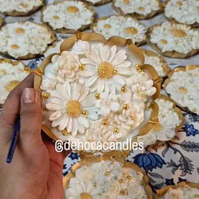 A close-up look at the hand-finished details of my white and gold floral urli candle. Each petal and pearl is carefully placed to create a stunning, intricate design.