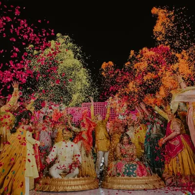 The ultimate Haldi moment. We live for this energy, capturing the explosion of colors, flowers, and laughter as friends and family shower the couple with love.