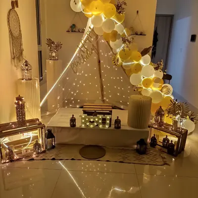 I can create a magical cabana or tent setup in your home for any special occasion. This one features a canopy with fairy lights, a balloon garland, and rustic lanterns for a warm, cozy feel.
