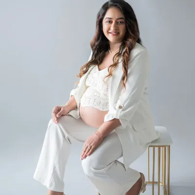 This expecting mother wanted to capture her "boss mom" energy, and I love how this portrait turned out. The white pantsuit and confident pose create a powerful and modern maternity photo that breaks away from traditional styles.