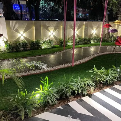 A beautifully lit garden path at night. I used a combination of wall-mounted uplights and low-level spotlights to illuminate the walkway, the surrounding plants, and the boundary wall, creating a magical atmosphere.