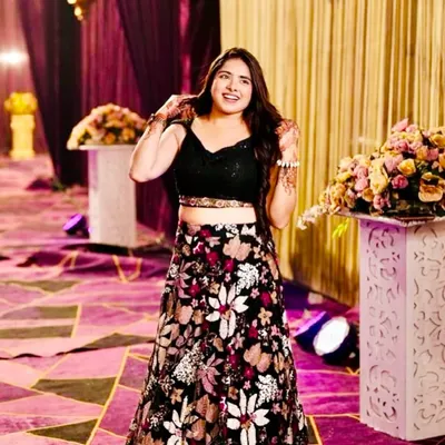A fun and festive look perfect for a sangeet or mehendi night. This rental features a black crop top paired with a vibrant floral embroidered lehenga skirt.