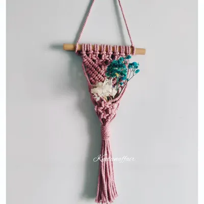 A lovely macrame mini plant hanger, perfect for a car, a doorway, or a nursery wall. You can decorate it with dried flowers, succulents, or air plants.