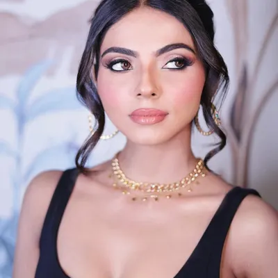 A sophisticated party look. This soft glam style features beautifully blended smokey eyes, glowing skin, and a glossy nude lip, perfect for any elegant evening event.