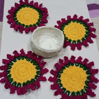 A complete set of my floral crochet coasters. This set of four comes with a matching white crocheted holder to keep them neatly stacked when not in use. They are perfect for protecting your table in style.