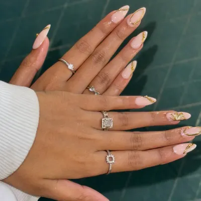 Get a closer look at this elegant nail set. I've crafted these long, almond-shaped extensions with a soft nude base and finished them with delicate gold foil accents. It's a perfect example of custom nail art that's both classy and on-trend.